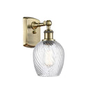 Salina Sconce shown in the Antique Brass finish with a Clear Spiral Fluted shade