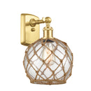 Farmhouse Rope Sconce shown in the Satin Gold finish with a Clear Glass with Brown Rope shade