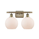 Athens Bath Vanity Light shown in the Antique Brass finish with a Matte White shade