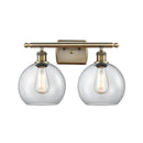 Athens Bath Vanity Light shown in the Antique Brass finish with a Clear shade