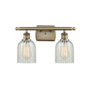 Caledonia Bath Vanity Light shown in the Antique Brass finish with a Mouchette shade