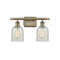 Caledonia Bath Vanity Light shown in the Antique Brass finish with a Mouchette shade