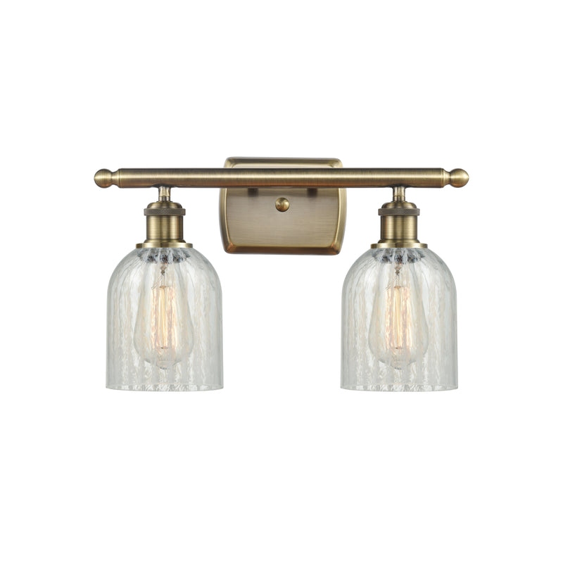 Caledonia Bath Vanity Light shown in the Antique Brass finish with a Mouchette shade