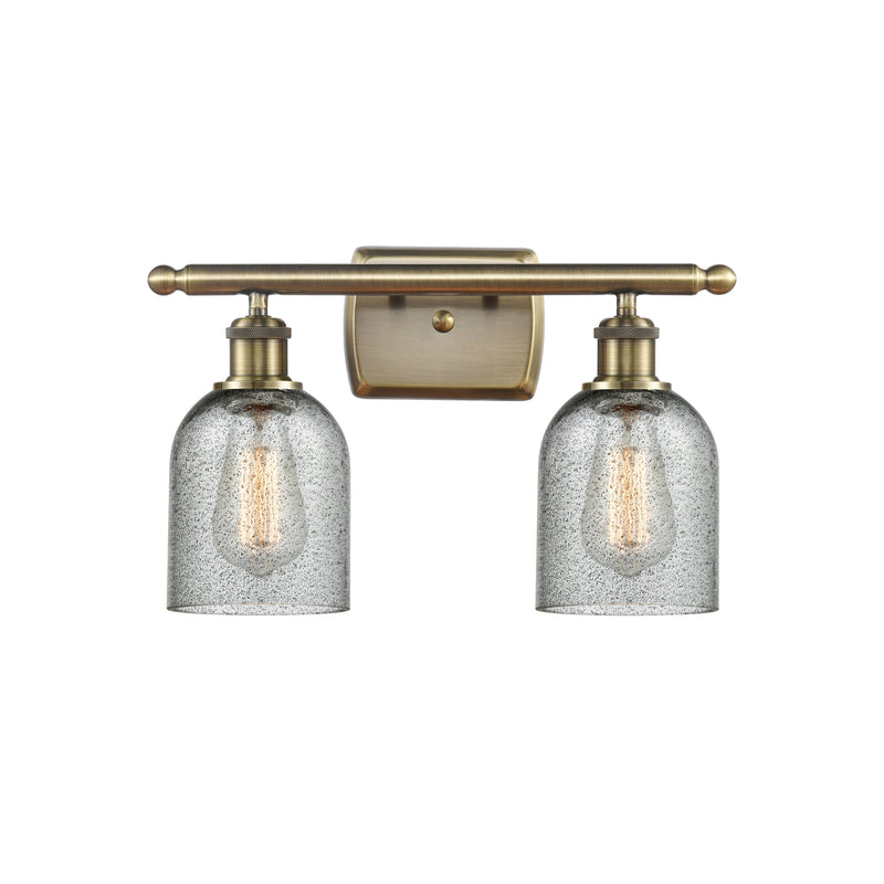 Caledonia Bath Vanity Light shown in the Antique Brass finish with a Charcoal shade