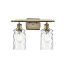 Candor Bath Vanity Light shown in the Antique Brass finish with a Clear Waterglass shade