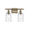 Candor Bath Vanity Light shown in the Antique Brass finish with a Clear Waterglass shade