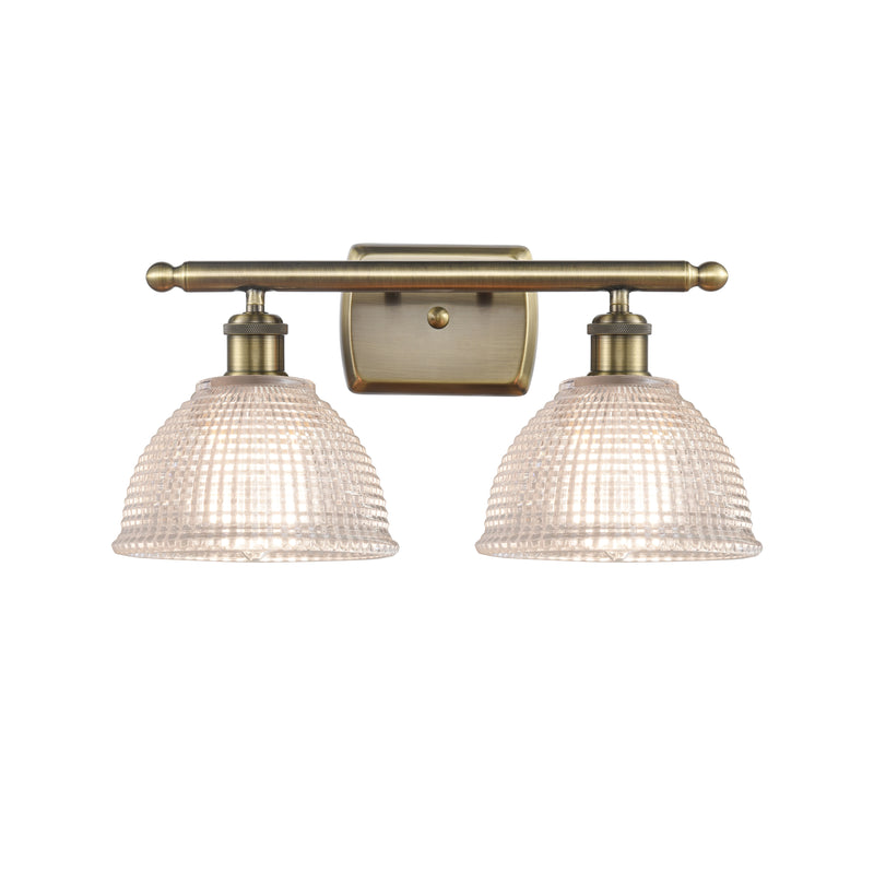 Arietta Bath Vanity Light shown in the Antique Brass finish with a Clear shade