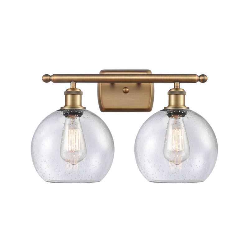 Athens Bath Vanity Light shown in the Brushed Brass finish with a Seedy shade