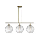 Deco Swirl Island Light shown in the Antique Brass finish with a Clear shade