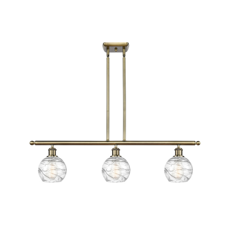 Deco Swirl Island Light shown in the Antique Brass finish with a Clear shade