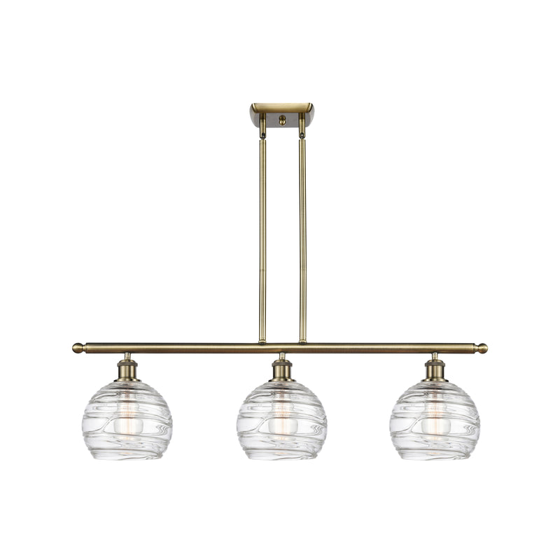 Deco Swirl Island Light shown in the Antique Brass finish with a Clear shade