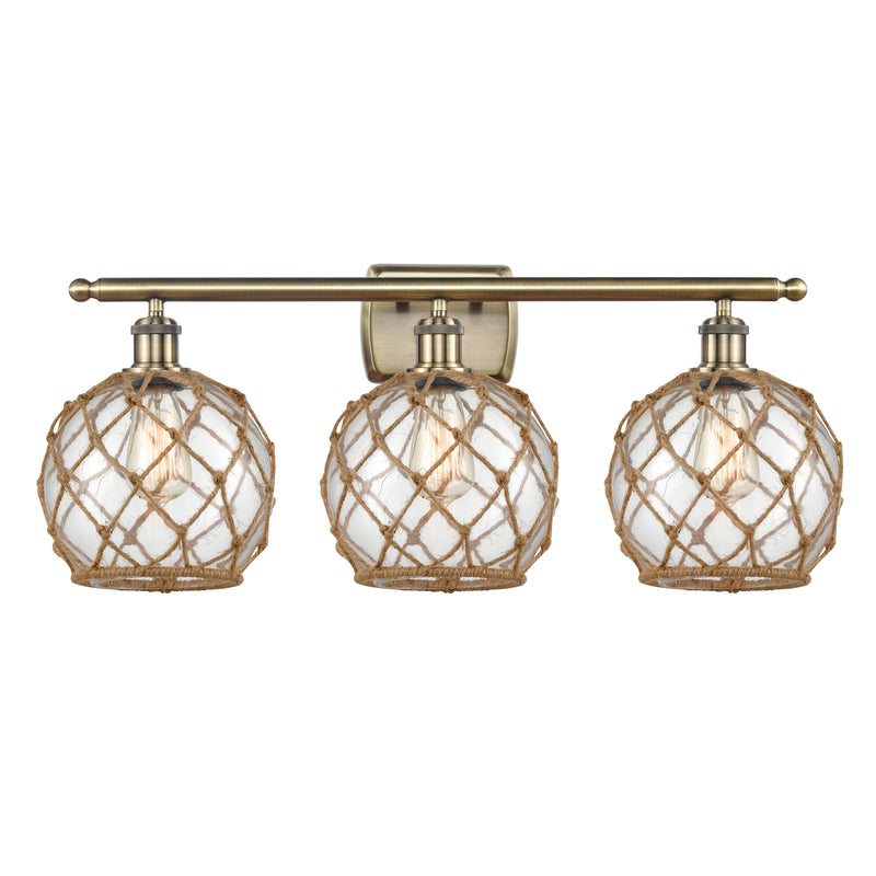 Farmhouse Rope Bath Vanity Light shown in the Antique Brass finish with a Clear Glass with Brown Rope shade