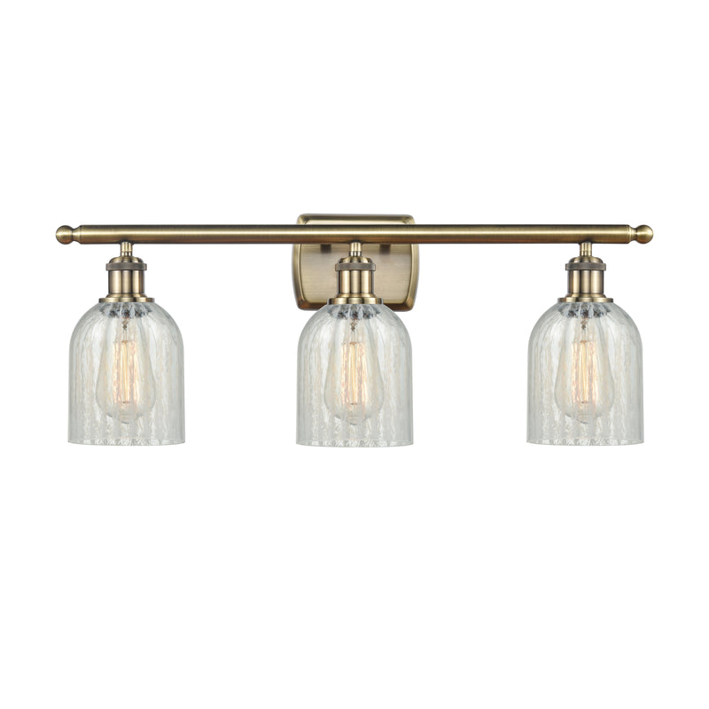 Caledonia Bath Vanity Light shown in the Antique Brass finish with a Mouchette shade