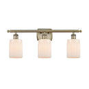 Hadley Bath Vanity Light shown in the Antique Brass finish with a Matte White shade