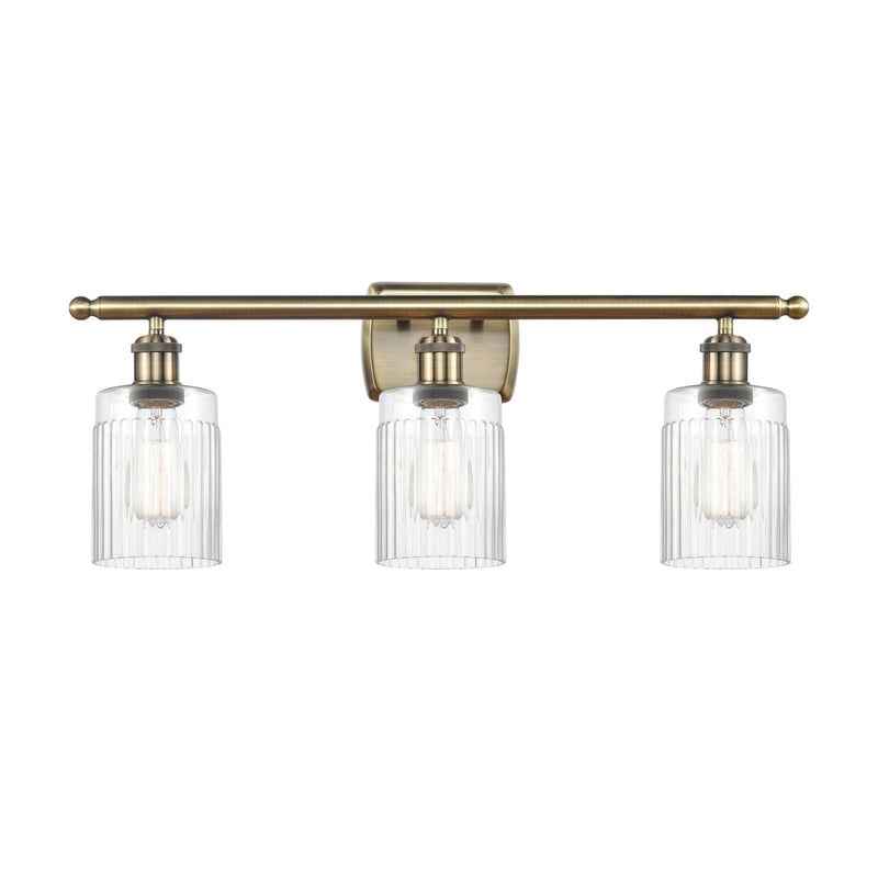 Hadley Bath Vanity Light shown in the Antique Brass finish with a Clear shade