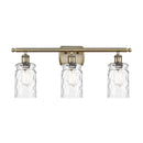 Candor Bath Vanity Light shown in the Antique Brass finish with a Clear Waterglass shade