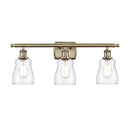 Ellery Bath Vanity Light shown in the Antique Brass finish with a Clear shade