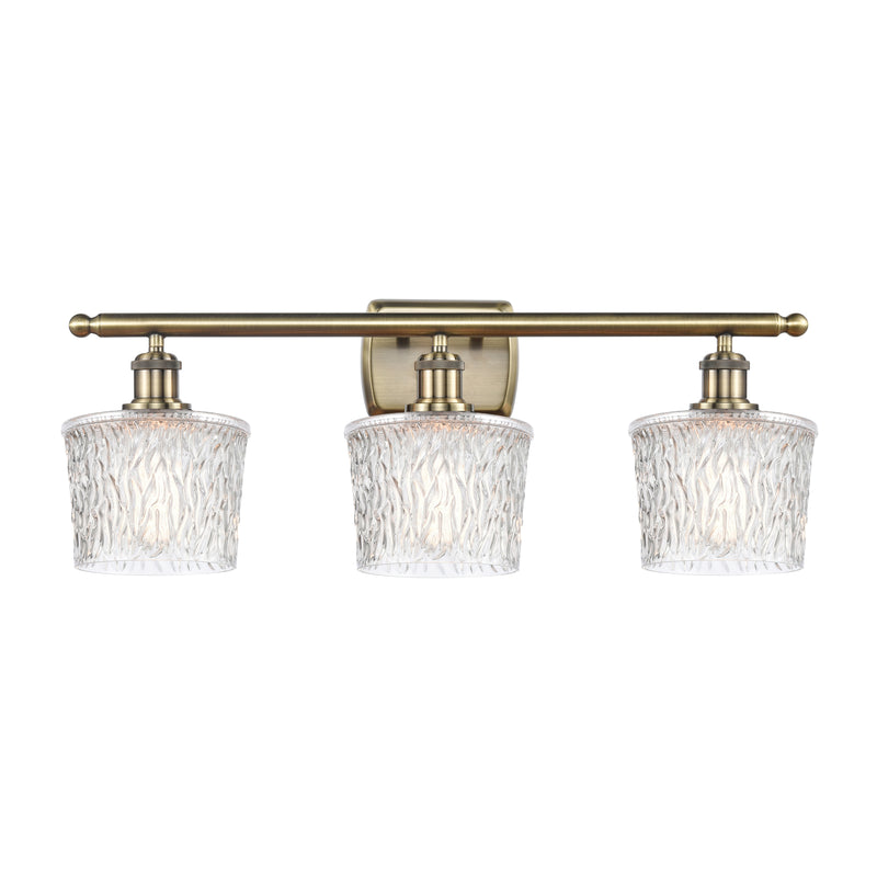 Niagra Bath Vanity Light shown in the Antique Brass finish with a Clear shade