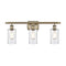 Clymer Bath Vanity Light shown in the Antique Brass finish with a Clear shade