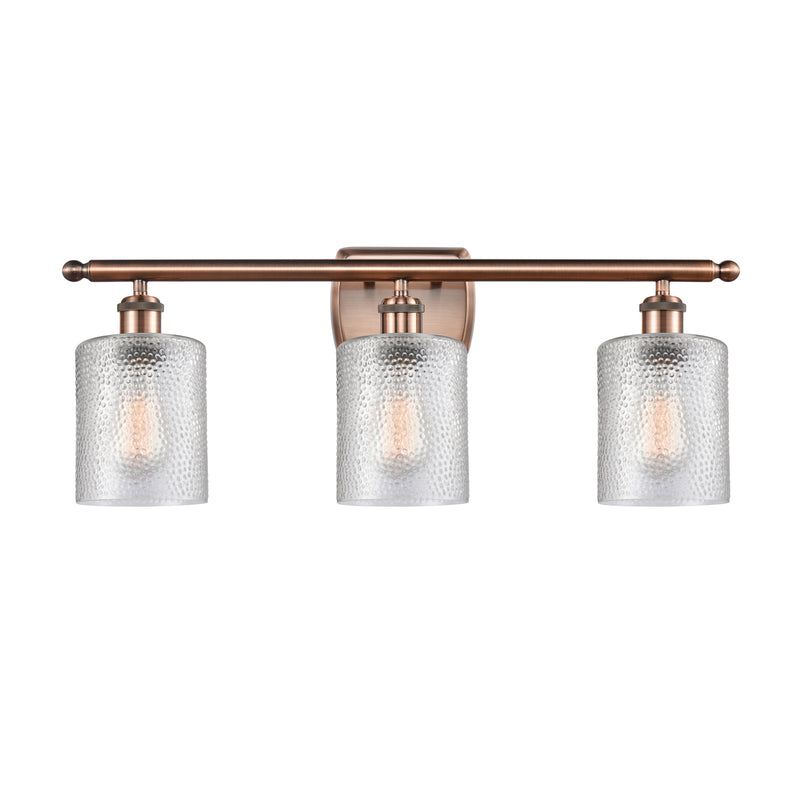 Cobbleskill Bath Vanity Light shown in the Antique Copper finish with a Clear shade