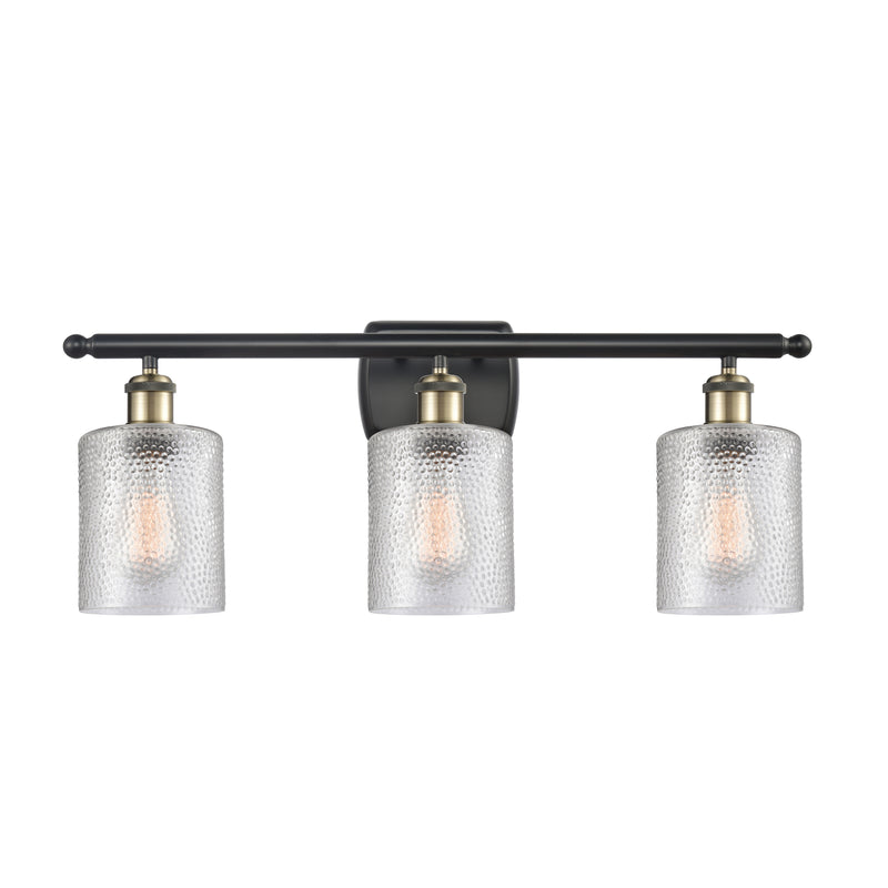 Cobbleskill Bath Vanity Light shown in the Black Antique Brass finish with a Clear shade