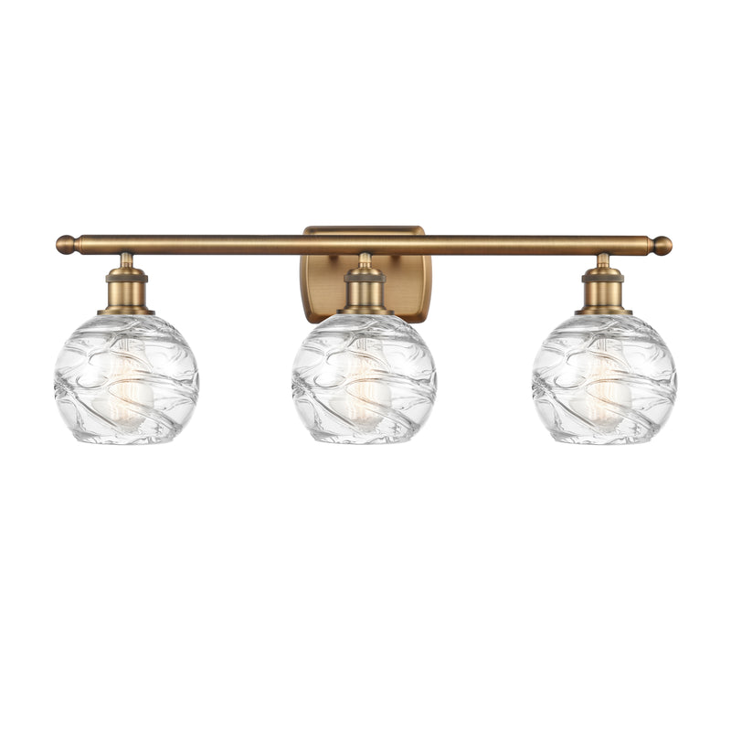 Deco Swirl Bath Vanity Light shown in the Brushed Brass finish with a Clear shade