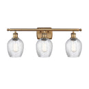 Salina Bath Vanity Light shown in the Brushed Brass finish with a Clear Spiral Fluted shade