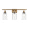 Candor Bath Vanity Light shown in the Brushed Brass finish with a Clear Waterglass shade