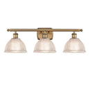 Arietta Bath Vanity Light shown in the Brushed Brass finish with a Clear shade