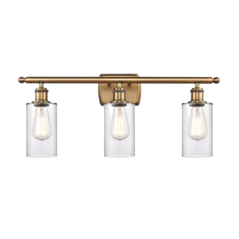 Clymer Bath Vanity Light shown in the Brushed Brass finish with a Clear shade