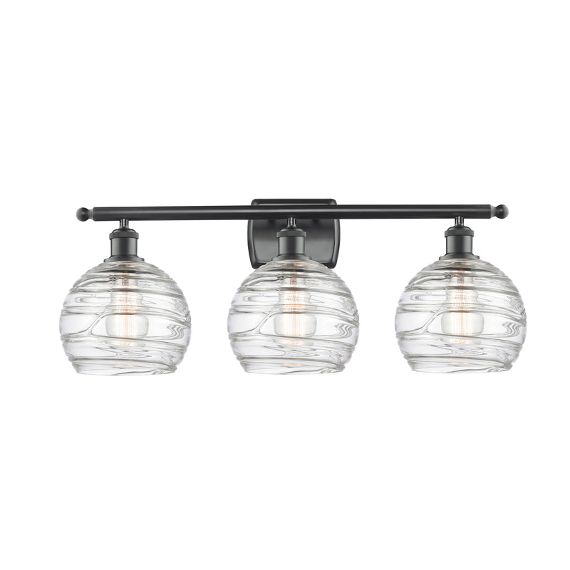 Deco Swirl Bath Vanity Light shown in the Matte Black finish with a Clear shade