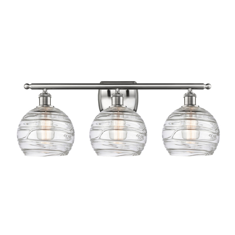 Deco Swirl Bath Vanity Light shown in the Brushed Satin Nickel finish with a Clear shade