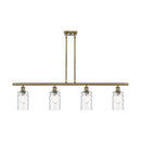 Candor Island Light shown in the Antique Brass finish with a Clear Waterglass shade