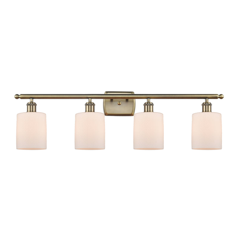 Cobbleskill Bath Vanity Light shown in the Antique Brass finish with a Matte White shade