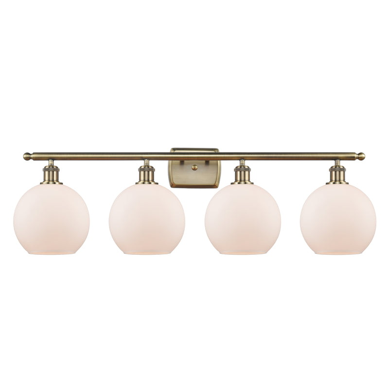 Athens Bath Vanity Light shown in the Antique Brass finish with a Matte White shade