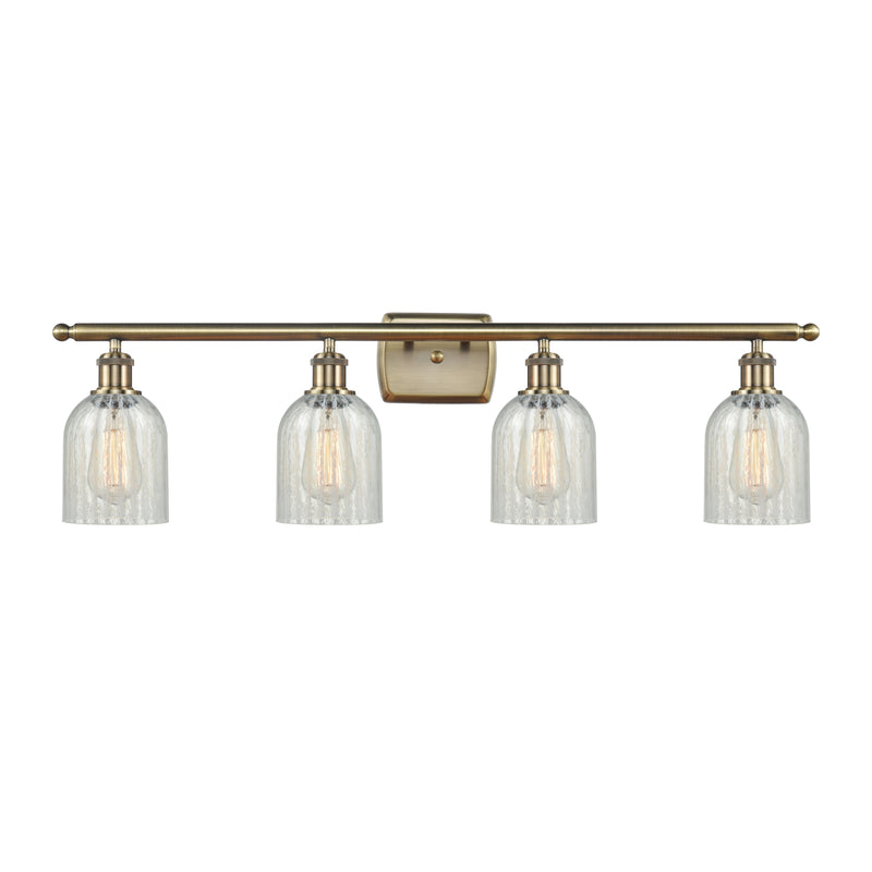 Caledonia Bath Vanity Light shown in the Antique Brass finish with a Mouchette shade