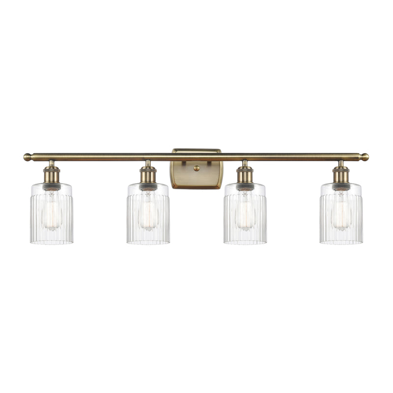 Hadley Bath Vanity Light shown in the Antique Brass finish with a Clear shade