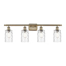 Candor Bath Vanity Light shown in the Antique Brass finish with a Clear Waterglass shade