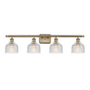 Dayton Bath Vanity Light shown in the Antique Brass finish with a Clear shade