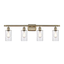 Clymer Bath Vanity Light shown in the Antique Brass finish with a Clear shade