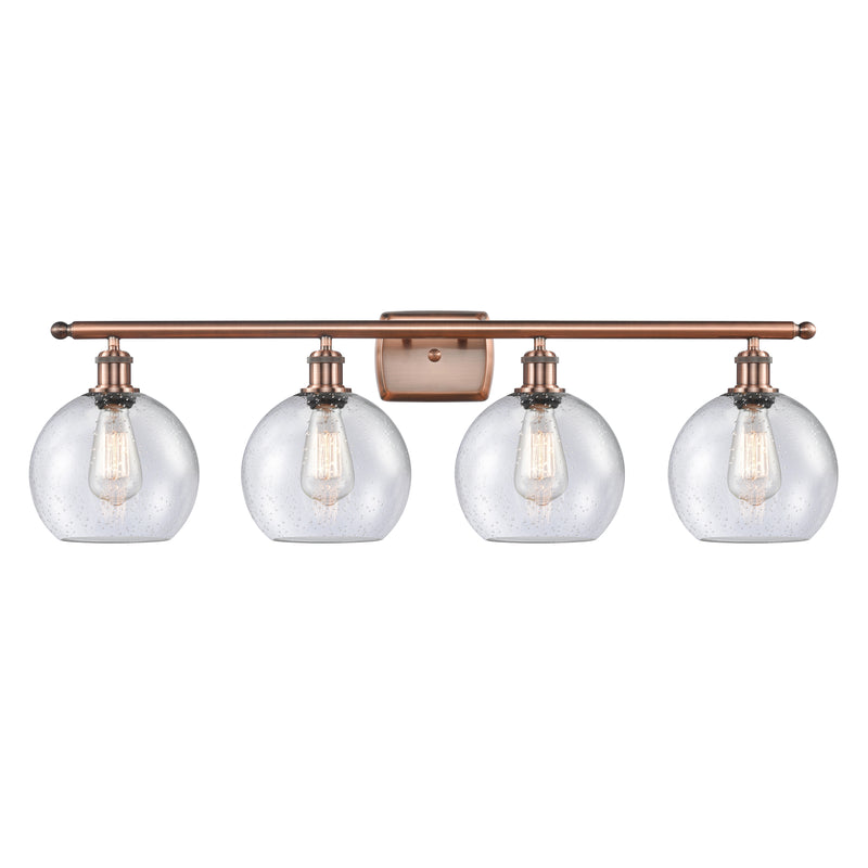 Athens Bath Vanity Light shown in the Antique Copper finish with a Seedy shade