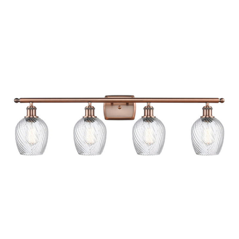 Salina Bath Vanity Light shown in the Antique Copper finish with a Clear Spiral Fluted shade