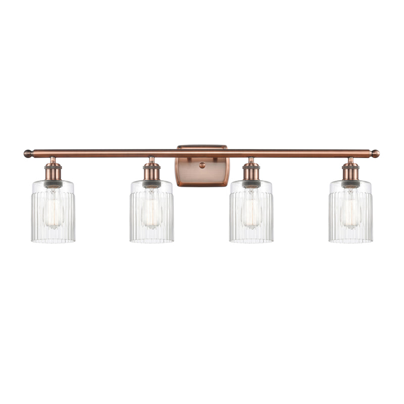 Hadley Bath Vanity Light shown in the Antique Copper finish with a Clear shade