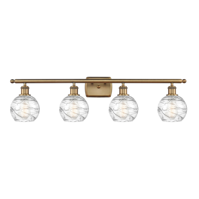 Deco Swirl Bath Vanity Light shown in the Brushed Brass finish with a Clear shade