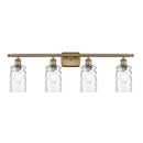 Candor Bath Vanity Light shown in the Brushed Brass finish with a Clear Waterglass shade