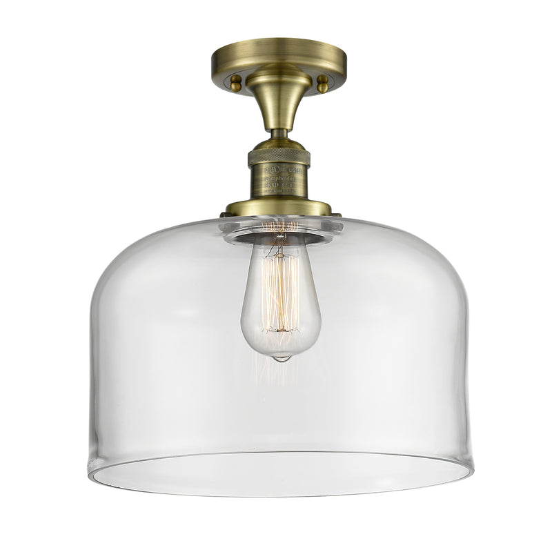 Bell Semi-Flush Mount shown in the Antique Brass finish with a Clear shade