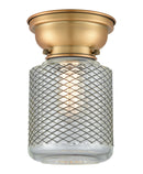 Stanton Flush Mount shown in the Brushed Brass finish with a Clear Wire Mesh shade