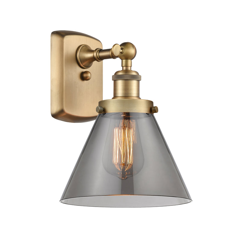 Cone Sconce shown in the Brushed Brass finish with a Plated Smoke shade