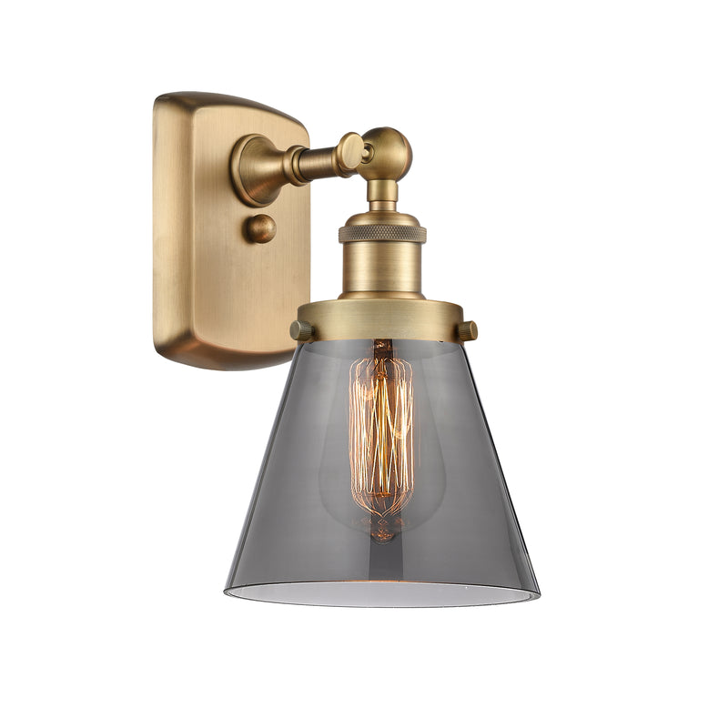 Cone Sconce shown in the Brushed Brass finish with a Plated Smoke shade