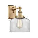 Bell Sconce shown in the Brushed Brass finish with a Clear shade